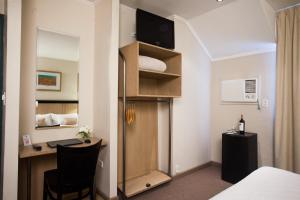 Cama ou camas em um quarto em Argentino Hotel