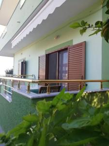 a view of the outside of a house with chairs at Jonny Guesthouse in Ksamil