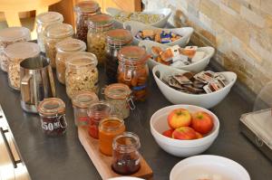 a counter with jars and bowls of food and apples at Gasthof Ramsauer in Neufahrn in Niederbayern