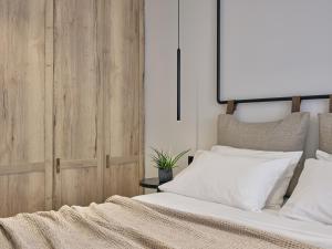 a bedroom with a bed with white pillows at Contessina Hotel in Tsilivi