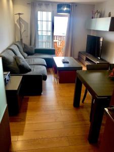 a living room with a couch and a table at Piso semicentrico con vistas a la bahía de Algeciras in Algeciras