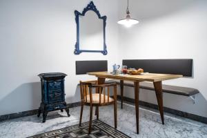 a dining room with a table and a wood stove at Carrara Bella in Carrara