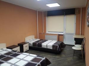 a room with two beds and a window in it at Hostel Korona in Belgorod