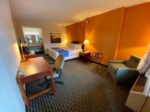 a hotel room with a bed and a desk at Days Inn by Wyndham Morehead in Morehead