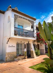 a white house with a balcony at Casa María in Nerja