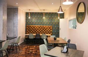 a restaurant with tables and chairs and a padded wall at New National Hotel and Conference in Parow