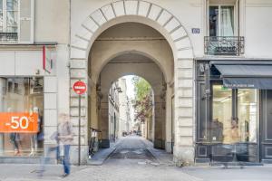 an archway over a street in a city at Apartment 3 people close Eiffel Tower by Weekome in Paris