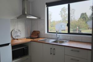 a kitchen with a sink and a large window at Southern Sky Glamping in Mount Tamborine