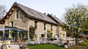 a stone house with lounge chairs in front of it at Château Serigues in Gap