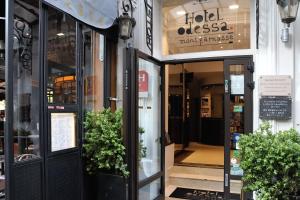 a store front of a store with doors open at Hôtel Odessa Montparnasse in Paris +31 photos