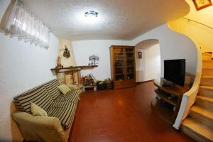 a living room with a couch and a television at Casa Ceragioli in Viareggio