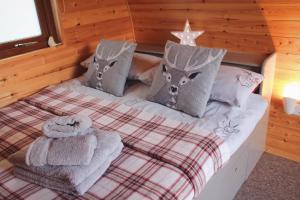 a bedroom with a bed with towels on it at Howe of Torbeg in Ballater