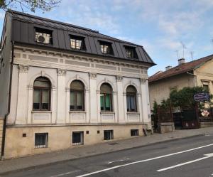 ein altes Gebäude am Straßenrand in der Unterkunft Vila Vidalis in Cluj-Napoca