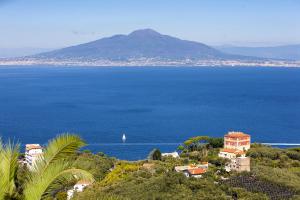 een uitzicht op de oceaan met een boot in het water bij Amore Rentals - Villa Bianca in Sorrento