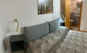 A bed or beds in a room at Rooms Teatro Greco
