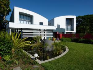 a white house with a pond in front of it at Serene-estate Boutique Guesthouse in St Lucia