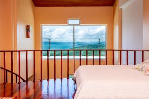 a hotel room with a view of the ocean at Lake Arenal Condos in Naranjos Agrios