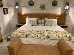 a bedroom with a large bed with a wooden headboard at RAIROYALE AT SAND CASTLES in Ocho Rios