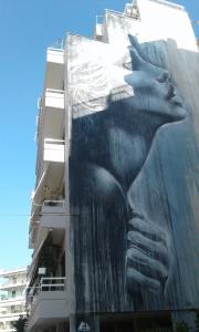 a building with a mural on the side of it at Apartment 110 sqm free parking in Patra