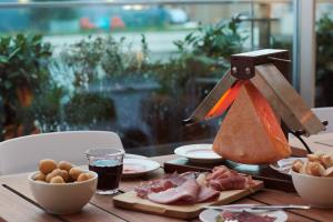 a wooden table with food on a table with aperature at Boundary Shoreditch in London