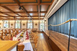 a large banquet hall with tables and chairs at Gasthof zum Stern in Seehausen am Staffelsee