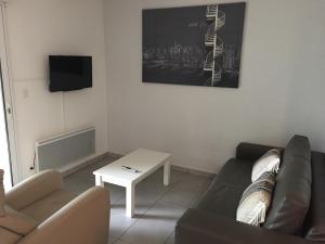 a living room with a couch and a table at Maison Lore Mendi Amotz in Saint-Pée-sur-Nivelle