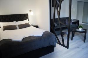Posteľ alebo postele v izbe v ubytovaní Black & White Apartament
