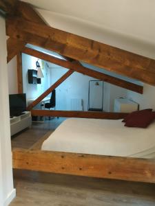 a bedroom with a large bed with wooden beams at Attic one bedroom flat in Old Town Lyon in Lyon