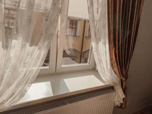 a window that is open in a room at Kurnakh Apartment in Lviv