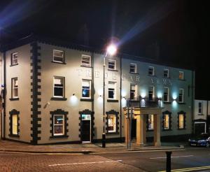 a building on the corner of a street at night at Tredegar Arms Hotel in Tredegar