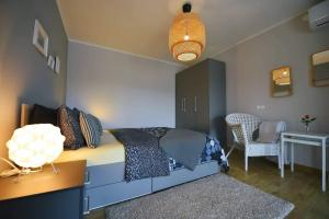 a bedroom with a bed and a table and a chair at Apartment Vanilla I with beautiful Seaview in Rabac