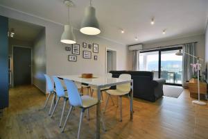 a dining room and living room with a table and chairs at Apartment Vanilla I with beautiful Seaview in Rabac