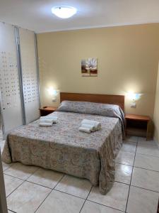 - une chambre avec un lit et 2 serviettes dans l'établissement Playa Apartment 230 - 230 bis, à Catane