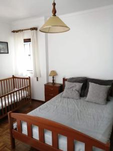 Postel nebo postele na pokoji v ubytování Casa Praia Légua