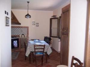 a kitchen with a table and chairs in a room at Villa Laura in Coccorino