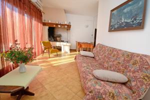 a living room with a couch and a table at Apartments with pool Albina in Umag