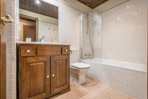 a bathroom with a sink and a toilet and a shower at Invernalia by Totiaran in Baqueira-Beret