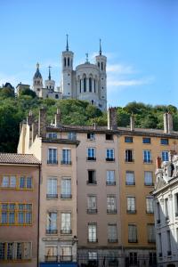 a building with a mountain in the background at Attic one bedroom flat in Old Town Lyon in Lyon