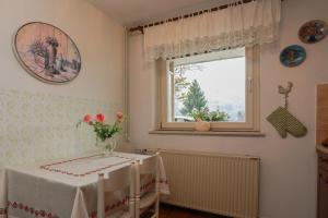 a dining room with a table and a window at Apartments Green Paradise in Bohinjska Bela +97 photos