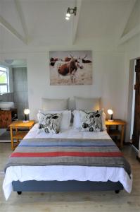 a bedroom with a large bed and two tables at Mysthill Farm cottages in George