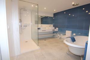 a bathroom with a shower and a toilet and a sink at Orly Club Coral Arena Dorada in Puerto del Carmen +12 photos