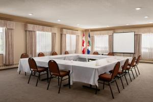 a large meeting room with a large table and chairs at Nova Inn Yellowknife in Yellowknife