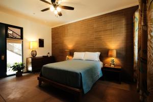 a bedroom with a large bed and a large window at The Downtown Clifton Hotel in Tucson