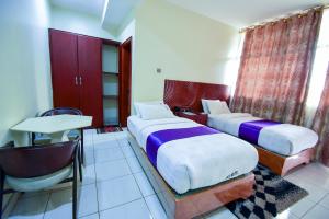 Postel nebo postele na pokoji v ubytování Hotel OK Kampala
