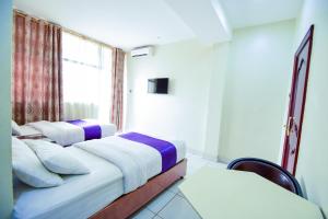 Postel nebo postele na pokoji v ubytování Hotel OK Kampala