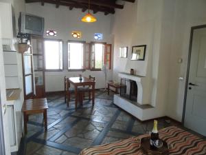 a living room with a table and a fireplace at Villa Enallaxis in Agios Dimitrios