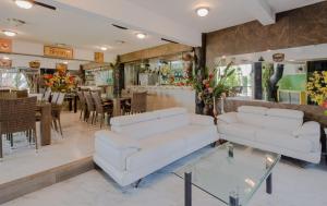 a living room with two white couches and a dining room at Private Villa 10 Rooms, Private Pool, Walk to Beach in Playa del Carmen