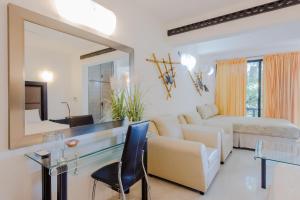 a living room with a couch and a mirror at Private Villa 10 Rooms, Private Pool, Walk to Beach in Playa del Carmen
