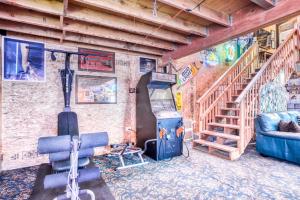 a room with a gym with a stove and a staircase at Getaway Bar on Easy Street in Rockaway Beach