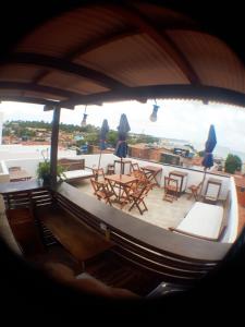 a view of a balcony with tables and chairs at La Estacion Hostel - Pipa in Pipa